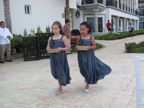Bridesmaids carrying rose petals